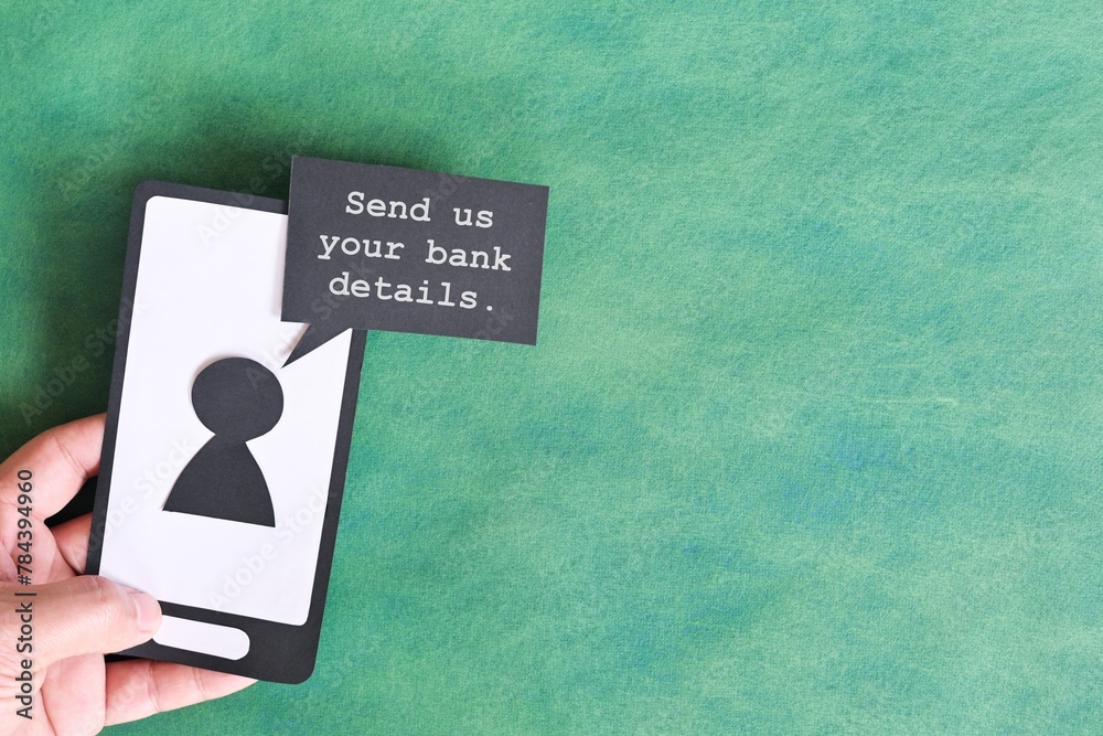 Send credit card bank details text message smishing scam concept. Hand holding mobile phone with message from unknown sender.