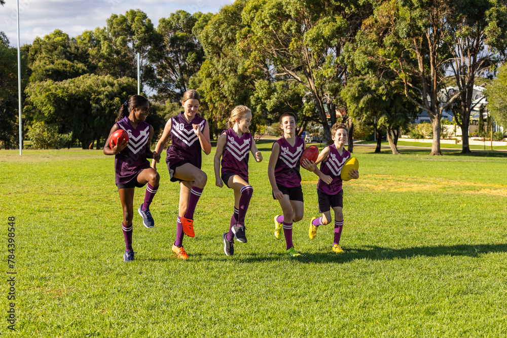 children in football team training on playing field children in football team training on playing field