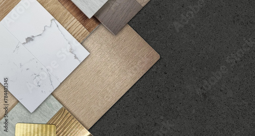 group of interior material samples including brushed gold stainless, bronze laminated, stone tile, wooden flooring tile, white marble quartz, veneer placed on black stone table in top view. © WONGSAKORN