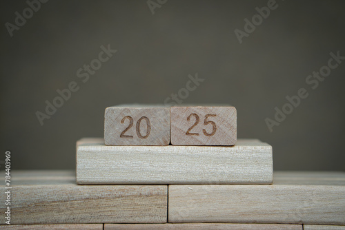 Number 2025 on wooden blocks with gray background. A concept of upcoming 2025 new year planning and goals. 