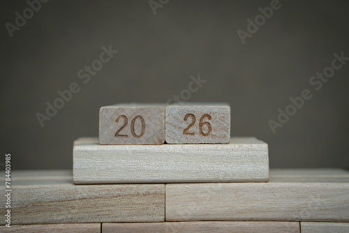 Number 2026 on wooden blocks with gray background. A concept of upcoming 2026 new year planning and goals. 