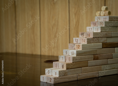 Numbers ascending on many wooden blocks. Concept of staircase and progress step by step with the reward ahead. 