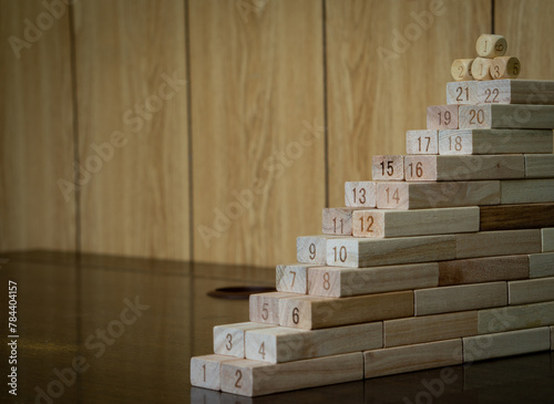 Numbers ascending on many wooden blocks. Concept of staircase and progress step by step with the reward ahead. 