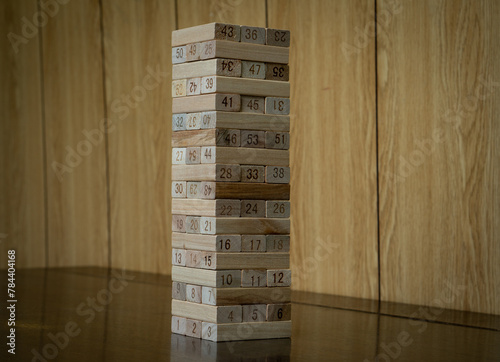 Wooden blocks stacking. Kid's wooden toy building a tower high. Indoor or table game for children. 