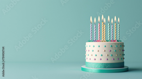 Chic birthday cake with pastel polka dots and nine brightly lit assorted candles on a dramatic backdrop