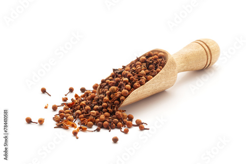 Front view of a wooden scoop filled with Organic Ceylon Ironwood or Nagkesar (Mesua ferrea) seeds. Isolated on a white background. photo