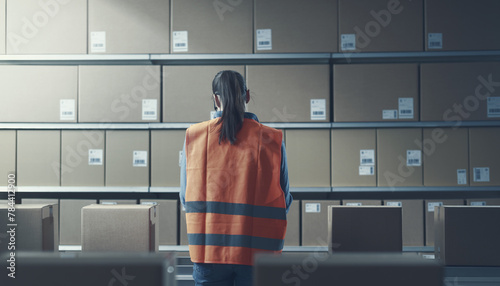 Warehouse worker checking boxes on the conveyor belt