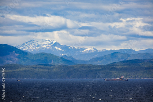 Panoramic morning or day time landscape nature coastal scenery with beautiful blue sky and dramatic cloudscapes in Alaska Inside Passage glacier mountain range view during cruise