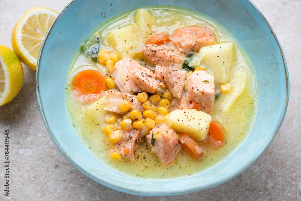 Middle close-up of chowder with salmon served in a turquoise bowl, horizontal shot, selective focus Middle close-up of chowder with salmon served in a turquoise bowl, horizontal shot, selective focus