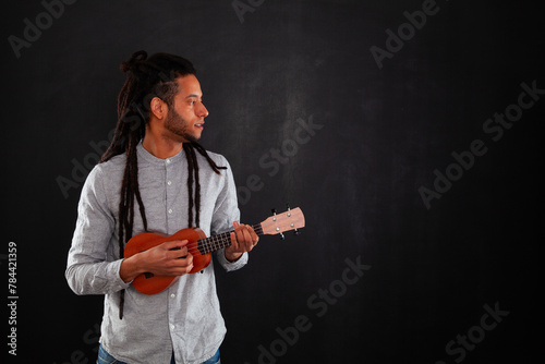 rastafari man holding a classic guitar
