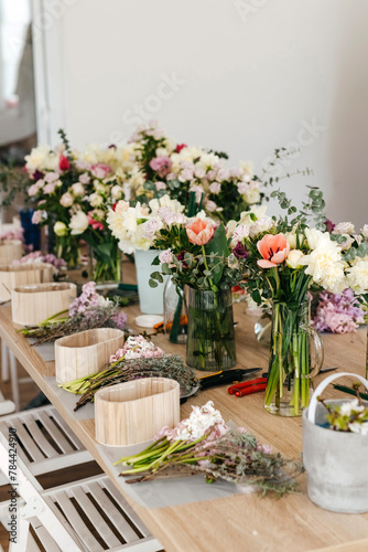 Floral arrangement workspace with fresh cut flowers.