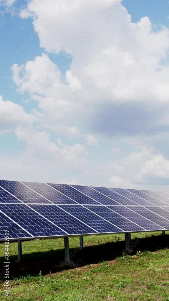Blue solar power station panels in row in fields green energy. Electrical ecology innovation nature environment. Vertical video.