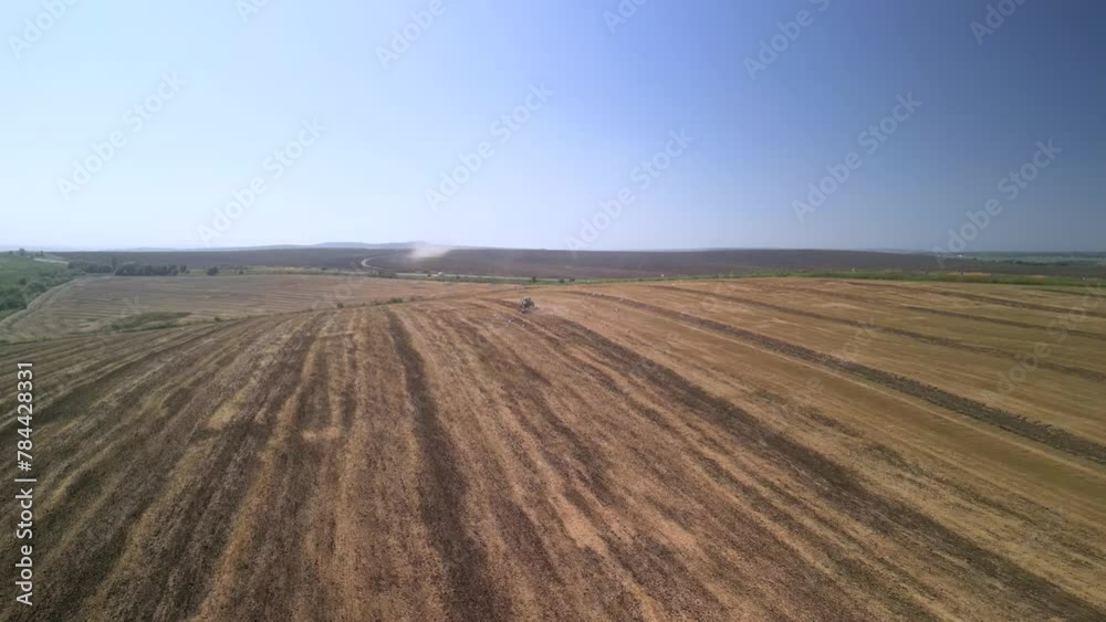 Tractor working on the field cultivating soil in Ukraine Tractor working on the field cultivating soil in Ukraine