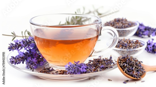 Cup of lavender tea on a white background. A cup of lavender tea and a teapot with fresh flowers on a white table. Herbal drink.