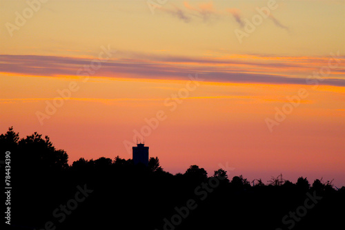 Old water tower in pastel colored sky at summertime