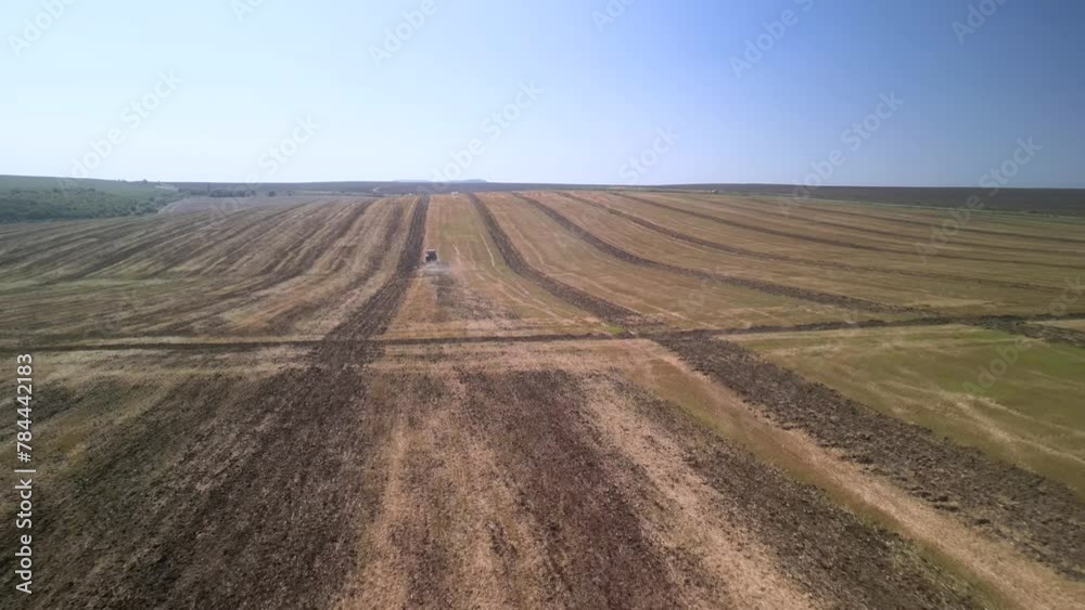 Tractor working on the field cultivating soil in Ukraine Tractor working on the field cultivating soil in Ukraine