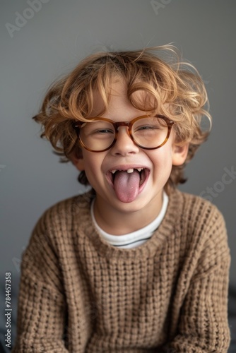 A little boy with glasses making a funny face. Great for children's books or educational materials © Fotograf