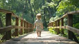 A little boy walking across a wooden bridge. Suitable for various projects