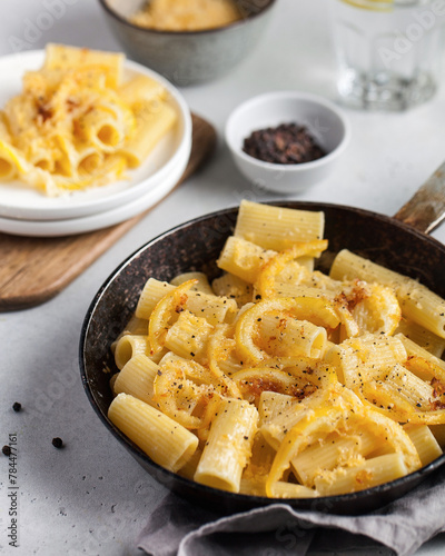 Delicious pasta with cheese sauce and lemon zest. Italian cuisine, the recipe.