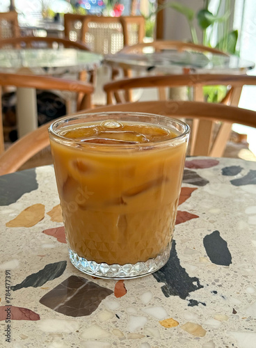 Close-up of a glass of fresh iced cold brew coffee with almond milk at a coffee shop in Izmir, Turkey
