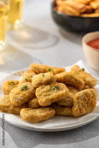 Delicious golden chicken nuggets on a plate close up. Fast food, menu.