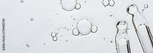 Two pipettes and a skin serum texture. Liquid body care product. Closeup. Copy space
