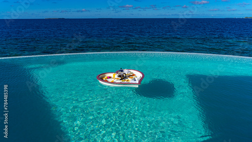 Floating Maldivian Breakfast in the swimming pool for some Honeymooners. photo