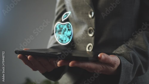 An animated apple with a turquoise flickering effect above the tablet screen in the hands of a businesswoman. The concept of introducing AI into the product sector. Cg
