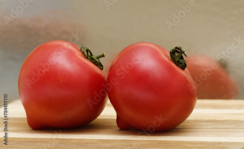 Round Pink tomato with a nose that produces heart shape when cut in half photo