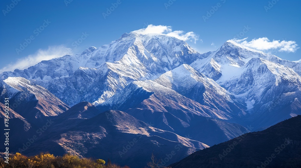 Obraz premium capped mountain range against a clear, blue sky