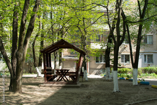 Wooden gazebo under the trees 