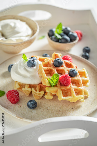 Homemade and delicious waffles with with raspberries and blueberries.