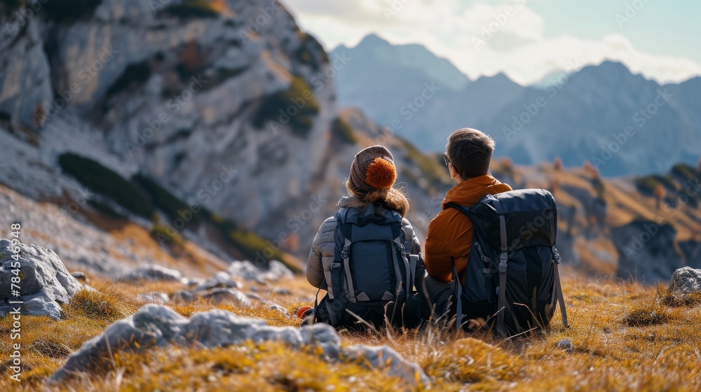 Fototapeta premium Carefree couple enjoys in view while taking break during hiking in nature