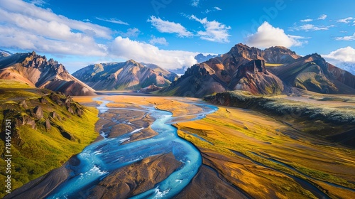 Majestic mountain landscape with vibrant river valley and blue skies