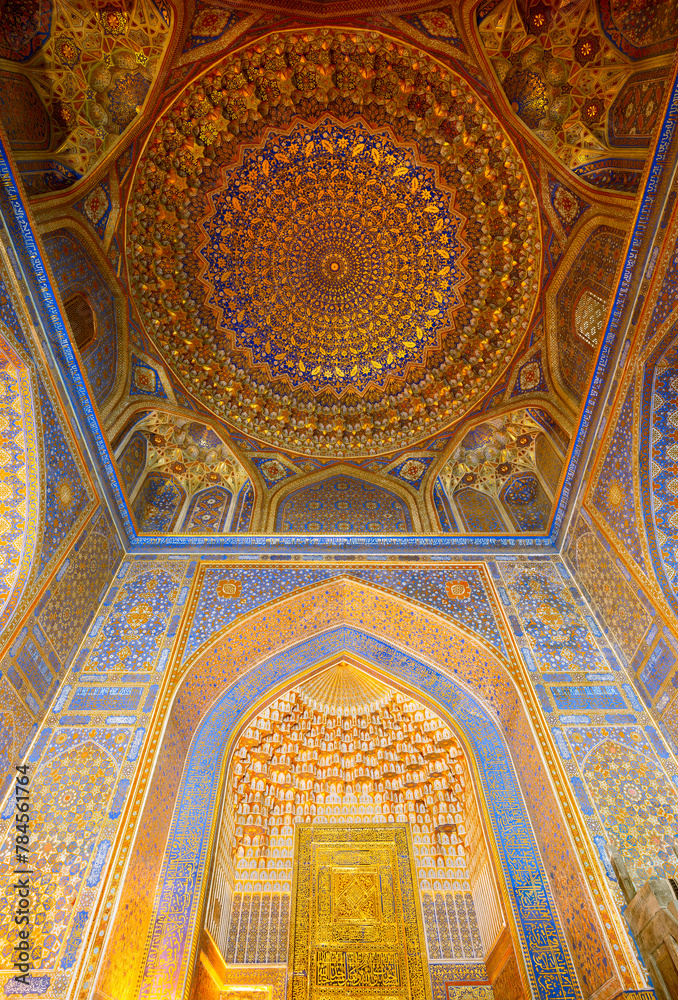 Samarqand, Uzbekistan - April - 04 - 2024: Interior with gold and blue colors of the Tillya-Kori Madrasah in the centre of Samarqand in Uzbekistan.