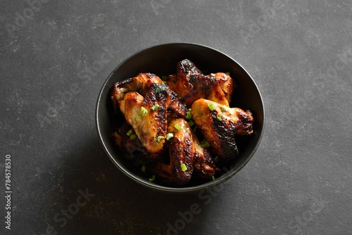 Grilled chicken wings in bowl. Close up view