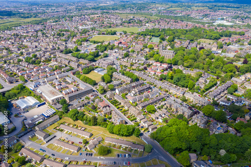 Aerial photo of the village of Pudsey in Leeds West Yorkshire in the UK, showing a typical British streets and houses, church and roads taken with a drone on a sunny summers day