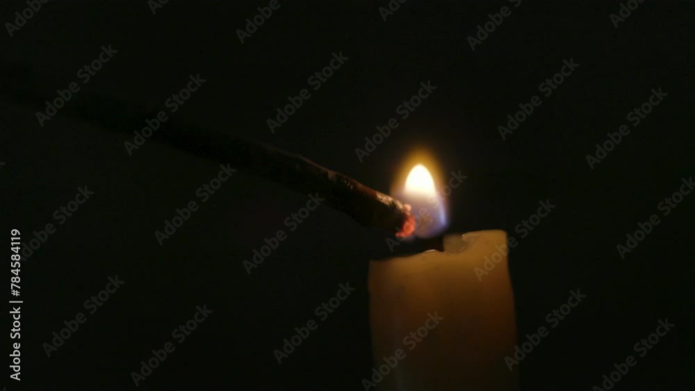 candle being lit by a stick or spill