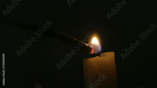 candle being lit by a stick or spill