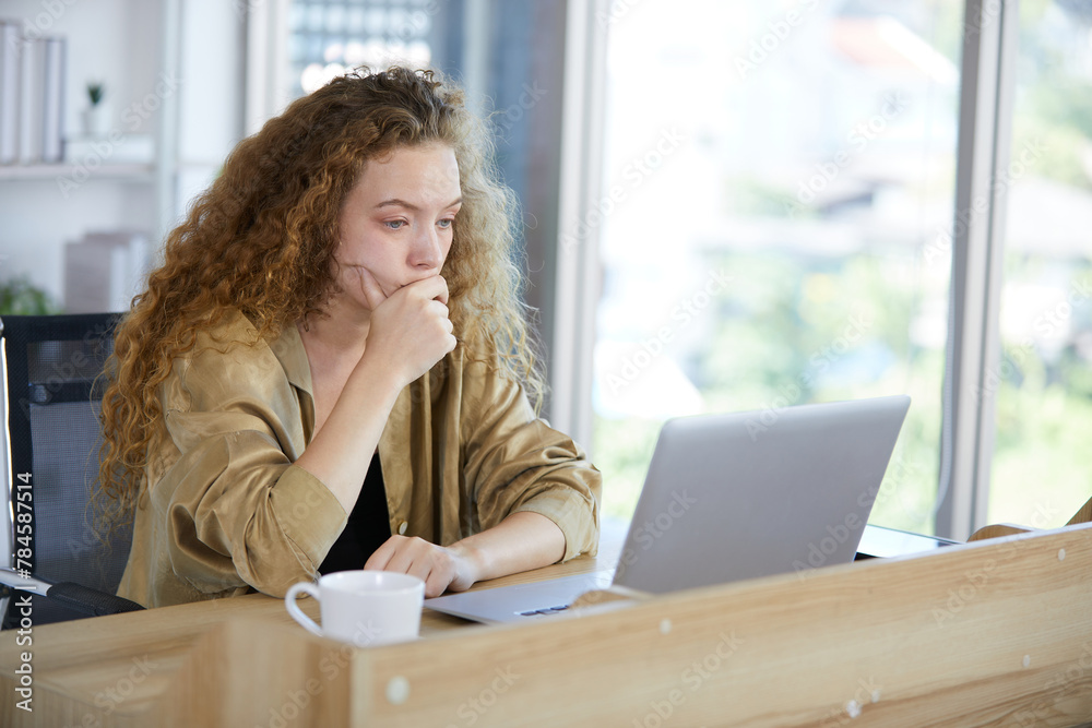 young woman working on laptop computer and feeling tired and worry from hard work in the office young woman working on laptop computer and feeling tired and worry from hard work in the office