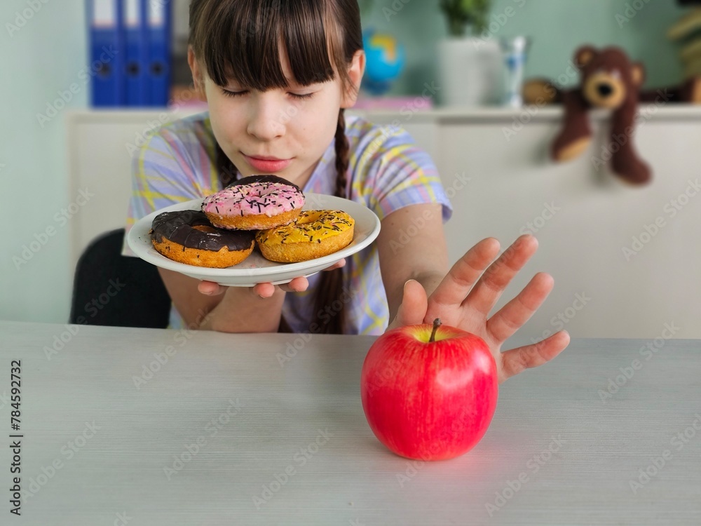 Teen girl pushing out avoid saying no to favorite donuts and sugar for good health and weight control diet and healthy Teen girl pushing out avoid saying no to favorite donuts and sugar for good health and weight control diet and healthy