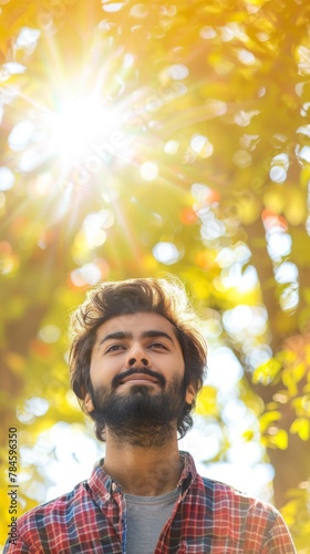 Serene Man Enjoying Sunlight in Autumn Forest