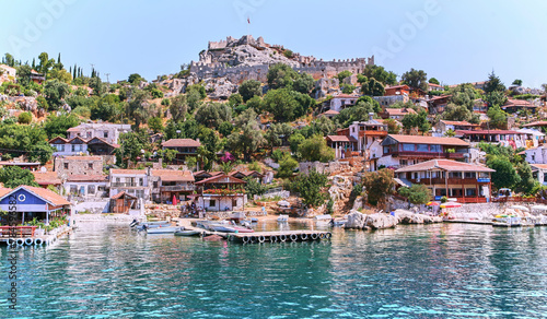 Scenic Turkish Village on Hill Overlooking Boats in Crystal Blue Sea
