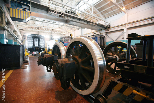 Railway maintenance workshop with locomotive and train wheels