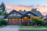 Front view drone of a Craftsman house at sunrise with the light casting warm hues on the facade