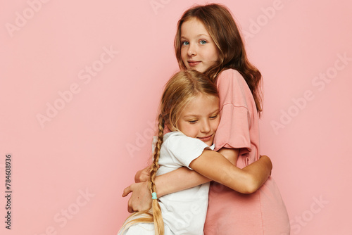 Two Sisters Embracing; Happy Siblings; Family Moments