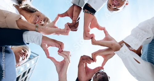 Love, support or business people with heart hands, care gesture or sky in community collaboration. Low angle, health or group of employees with teamwork, wellness symbol or thank you sign outdoors photo