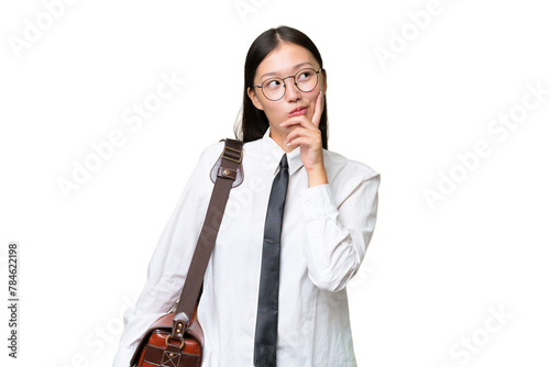 Young Asian business woman over isolated background having doubts and with confuse face expression © luismolinero