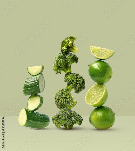 Creative layout made of broccoli, cucumber and lime on the green background. Food concept. Macro concept. (ID: 784624986)