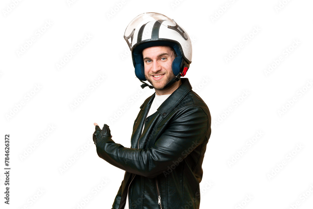 Young handsome blonde man with a motorcycle helmet over isolated chroma key background pointing back Young handsome blonde man with a motorcycle helmet over isolated chroma key background pointing back